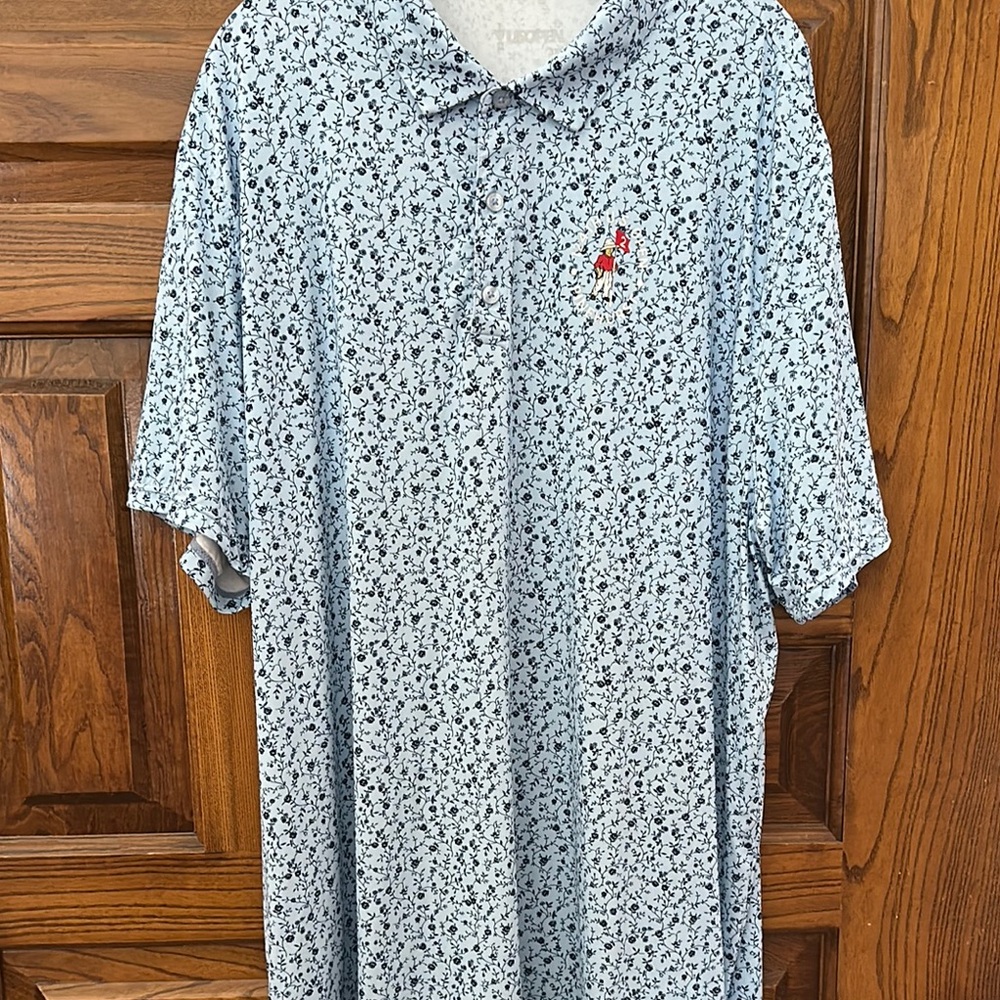 Blue Polo Shirt with White Pattern and Red Emblem